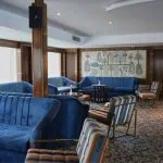 Swimming pool and sunbeds on a cruise ship's sundeck with a view of the Nile.