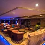 A lounge area on the MS Royal La Terrasse Nile Cruise with blue neon lights and cushioned seating.