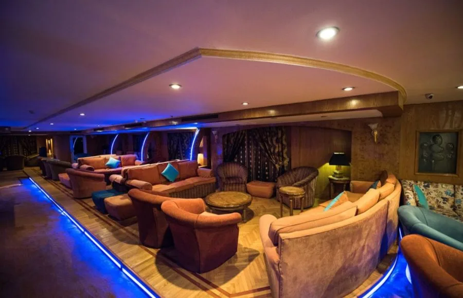 A lounge area on the MS Royal La Terrasse Nile Cruise with blue neon lights and cushioned seating.