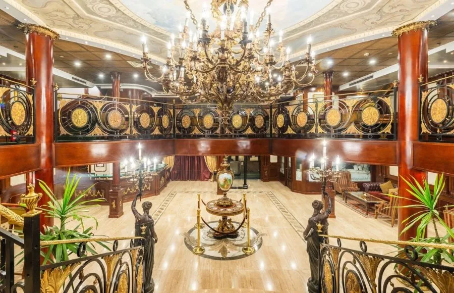 A plush lobby and upstairs area with an ornate chandelier on the MS Royal Princes Nile Cruise.