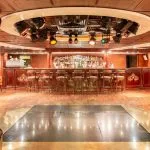 Luxurious lounge bar with wood paneling and gold accents aboard the MS Royal Princess Nile cruise ship.