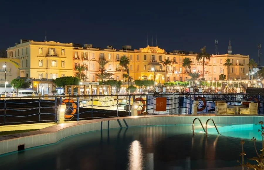 Luxor's Sofitel Winter Palace Hotel at night viewed from an adjacent Nile cruise ship pool.