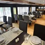 An elegantly set dining room on the MS Salima Nile Cruise ship, ready to welcome guests for a meal