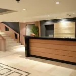 The elegant and welcoming reception desk of the MS Salima Nile Cruise, featuring warm wood accents and a modern design