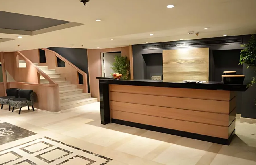 The elegant and welcoming reception desk of the MS Salima Nile Cruise, featuring warm wood accents and a modern design