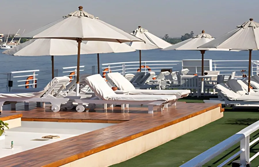 Relax under the sun on the spacious deck of the Salima Nile Cruise, featuring comfortable loungers and umbrellas for ultimate comfort as you sail.