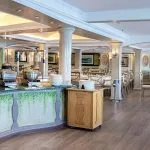 The elegant dining room aboard the Sonesta Moon Goddess Nile Cruise ship, showcasing a buffet station and beautifully set tables.