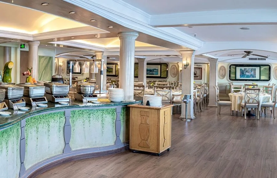 The elegant dining room aboard the Sonesta Moon Goddess Nile Cruise ship, showcasing a buffet station and beautifully set tables.