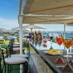The vibrant bar area on the sun deck of the Sonesta Moon Goddess Nile Cruise ship, serving refreshing drinks and snacks next to the pool.