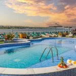 the inviting swimming pool on the sun deck of the Sonesta Moon Goddess Nile Cruise ship, perfect for a refreshing dip under the Egyptian sun.