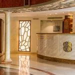 The welcoming reception area of the Sonesta Moon Goddess Nile Cruise ship, featuring a elegant marble counter and warm lighting.