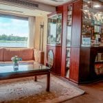The on-board gift shop and lounge on the Ms Nile Goddess Nile Cruise, featuring display cases and comfortable seating with a view of the Nile.