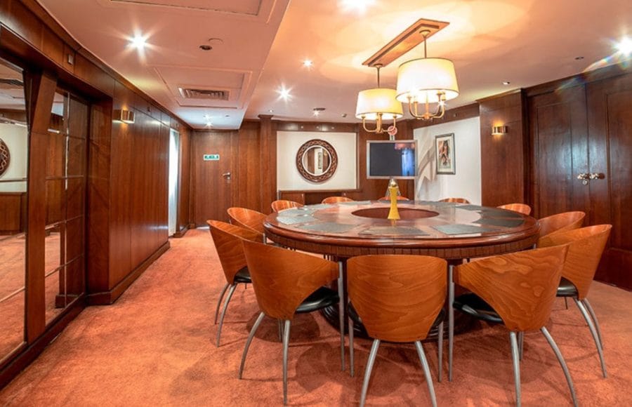 The elegant meeting room aboard the MS Nile Goddess Nile Cruise, featuring a large circular table and modern decor.