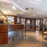 The welcoming reception area of the MS Nile Goddess Nile Cruise with a wooden front desk and a staircase.