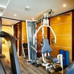 The compact and well-equipped gym on the MS Sonesta St George Nile Cruise, featuring a treadmill, weight machine, and other fitness equipment for guests to use while on board.
