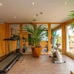 The well-equipped gymnasium on the MS Sonesta Sun Goddess Nile River Cruise, featuring a treadmill, exercise bike, and large windows.