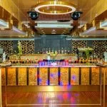 The sophisticated lounge bar on the Sonesta Sun Goddess Nile cruise ship, featuring a beautifully lit bar and a variety of colorful drinks.