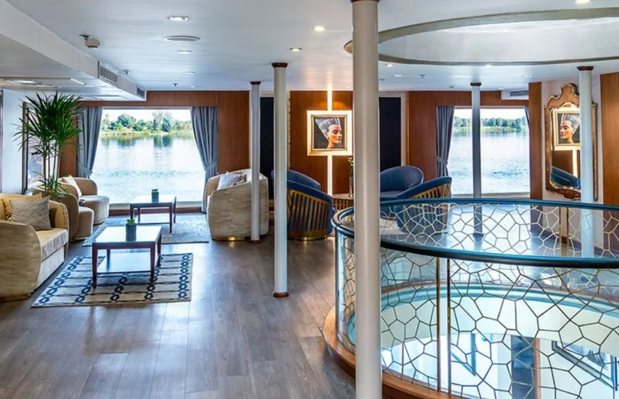 The elegant lounge on the Sonesta Sun Goddess Nile cruise ship, with comfortable seating and large windows overlooking the beautiful Nile River.