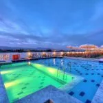 The swimming pool on the Steigenberger Legacy cruise ship at dusk.