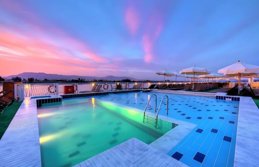 The swimming pool on the MS Steigenberger Minerva cruise ship at sunset.