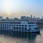 The Steigenberger Royale Nile Cruise ship on the river at sunset.