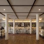 The chic main bar and lounge area on the MS Tamr Henna Nile Cruise features a beautiful marble bar stylish patterned seating and warm lighting perfect for evening relaxation