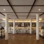 The chic main bar and lounge area on the MS Tamr Henna Nile Cruise features a beautiful marble bar stylish patterned seating and warm lighting perfect for evening relaxation