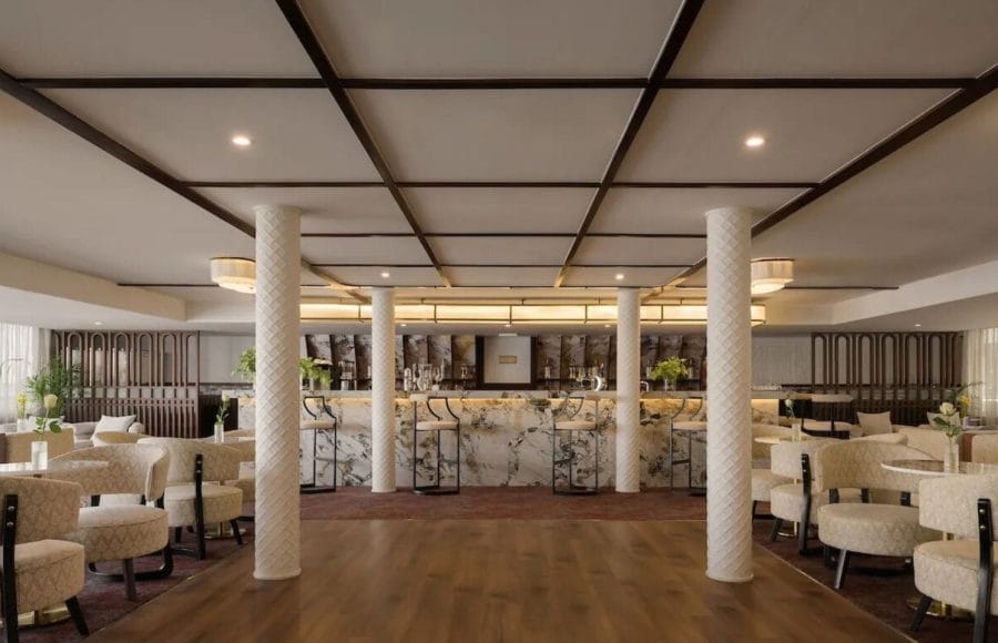 The chic main bar and lounge area on the MS Tamr Henna Nile Cruise features a beautiful marble bar stylish patterned seating and warm lighting perfect for evening relaxation