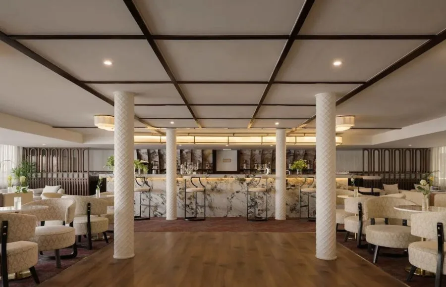 The chic main bar and lounge area on the MS Tamr Henna Nile Cruise features a beautiful marble bar stylish patterned seating and warm lighting perfect for evening relaxation