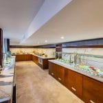 The elegant buffet area on the Tamar Henna nile cruise features marble countertops rich wood paneling and a vibrant display of fresh fruits and colorful salads