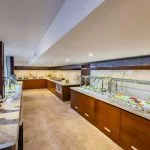 The elegant buffet area on the Tamar Henna nile cruise features marble countertops rich wood paneling and a vibrant display of fresh fruits and colorful salads
