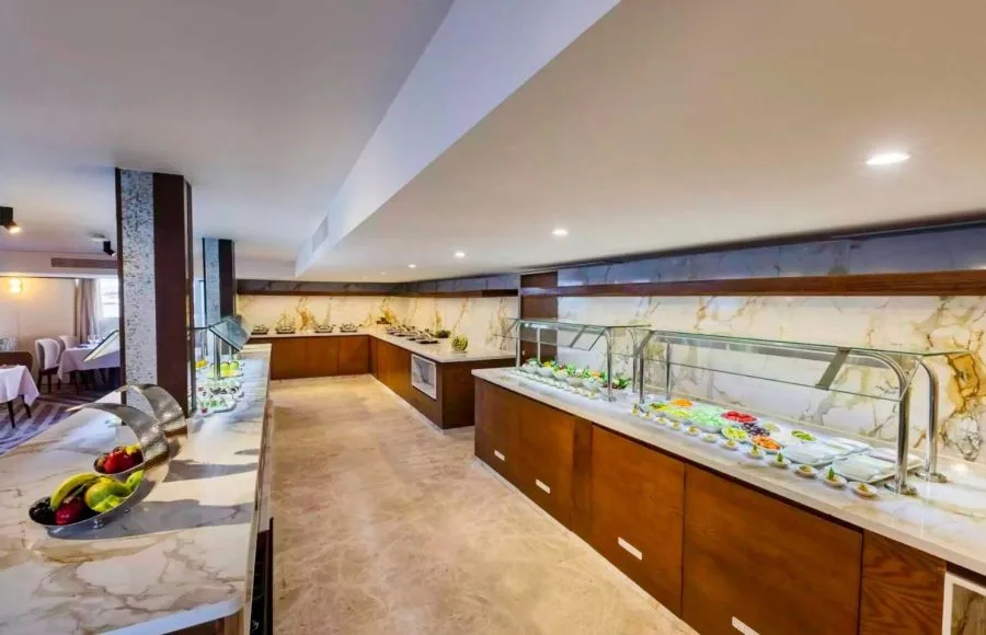 The elegant buffet area on the Tamar Henna nile cruise features marble countertops rich wood paneling and a vibrant display of fresh fruits and colorful salads