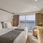 The clean and elegant buffet area on the Tamar Henna nile cruise offers a wide selection of fresh fruits and salads on marble counters and wood paneling