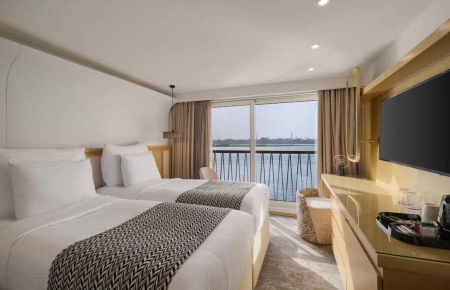 The clean and elegant buffet area on the Tamar Henna nile cruise offers a wide selection of fresh fruits and salads on marble counters and wood paneling