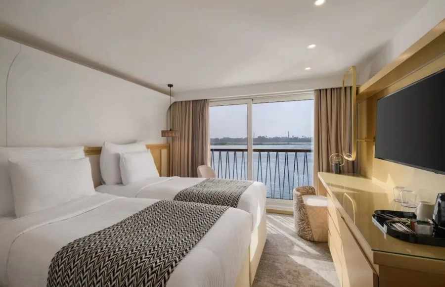 The clean and elegant buffet area on the Tamar Henna nile cruise offers a wide selection of fresh fruits and salads on marble counters and wood paneling