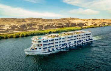 The majestic Tamr Henna Nile Cruise Ship navigates the historic waters of the Nile offering travelers a luxurious journey between the lush banks and the dramatic desert landscape