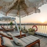 The beautiful sun deck of the Tamr Henna Nile Cruise Ship features stylish lounge chairs and macrame umbrellas offering the perfect vantage point for a stunning Nile sunset