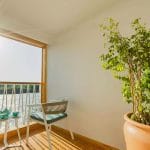 The private cabin terrace on the Tamar Henna nile cruise offers stunning sunlit views of the river from comfortable chairs perfect for enjoying a morning tea or coffee