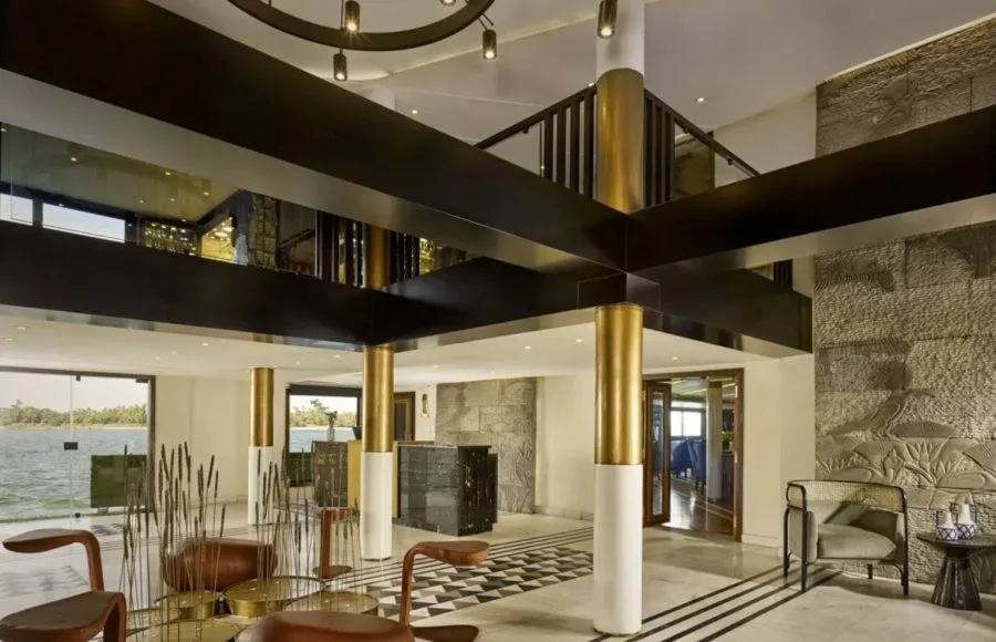 The luxurious, modern lobby and reception area of the MS Tulip Nile Cruise features gold pillars, stylish seating, and panoramic windows overlooking the river.