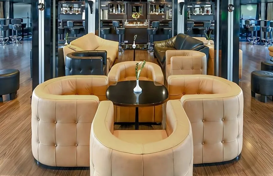The lounge on the Moondance Nile Cruise features comfortable leather seating, a stylish bar, and elegant lighting for relaxation.