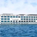 H/S Moondance Nile cruise ship sailing on the Nile River under a clear sky, offering a luxurious and unforgettable travel experience.