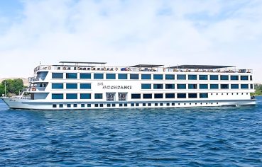 H/S Moondance Nile cruise ship sailing on the Nile River under a clear sky, offering a luxurious and unforgettable travel experience.