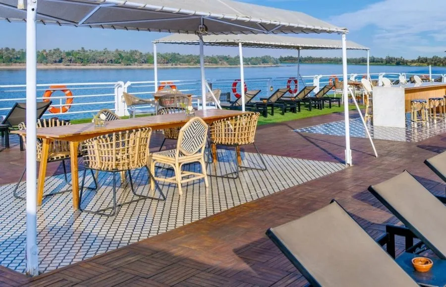 Movenpick MS Sunray sun deck with wicker dining and lounge chairs offering beautiful views during the Nile Cruise.