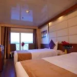 A comfortable twin-bed cabin on the Blue Shadow 4 Nile Cruise, with two single beds and a large window.