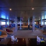 The modern lounge bar on the Blue Shadow IV, featuring comfortable seating and a sleek bar area.