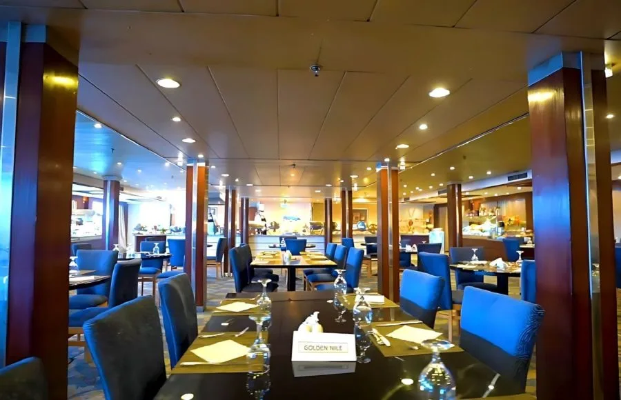 The elegant dining room on the Blue Shadow 4, with tables and plush chairs.