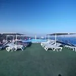 The spacious sun deck of the Blue Shadow 4 Nile Cruise, featuring rows of sun loungers and a view of the Nile River.