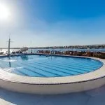 The swimming pool on the sun deck of the Blue Shadow IV, with a serene view of the Nile River.