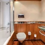 The comfortable and well-appointed bathroom on the Sindbad Nile cruise, featuring a bathtub and modern amenities, offers a relaxing space for your journey.