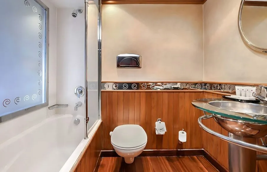 The comfortable and well-appointed bathroom on the Sindbad Nile cruise, featuring a bathtub and modern amenities, offers a relaxing space for your journey.